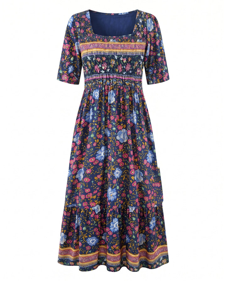 Women's square neck navy boho midi dress with pink and blue floral print, shirred bodice, and tiered skirt.