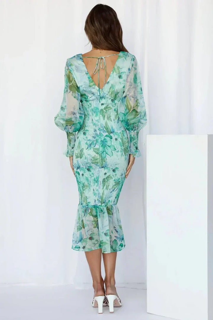 Davina women's floral smocked V-neck midi dress in green with sheer long sleeves and ruffle hem.