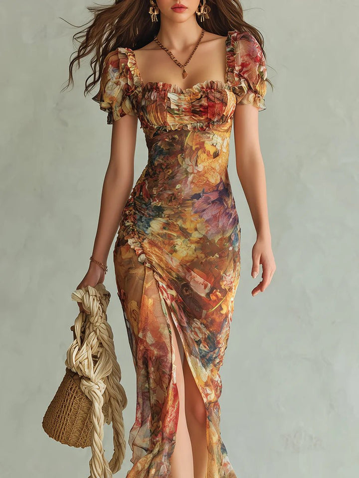 Women's Edelyn ruffle sweetheart chiffon boho dress in a vibrant floral print with a high slit, holding a woven bag.