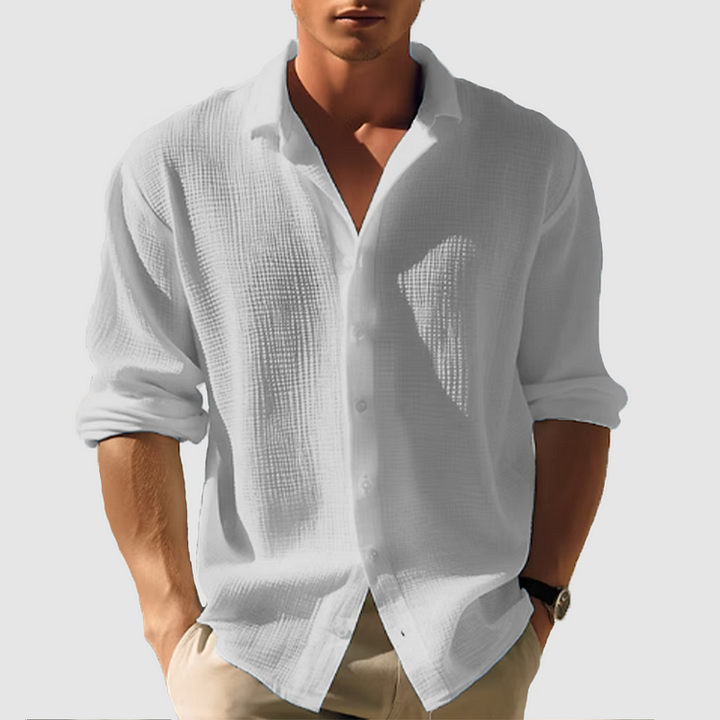 Men's white textured linen button-up shirt with rolled long sleeves and a collared neckline.