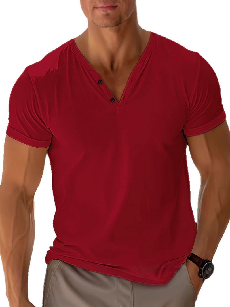 Men's red short sleeve V-neck t-shirt with button detail and soft drape, paired with light pants.