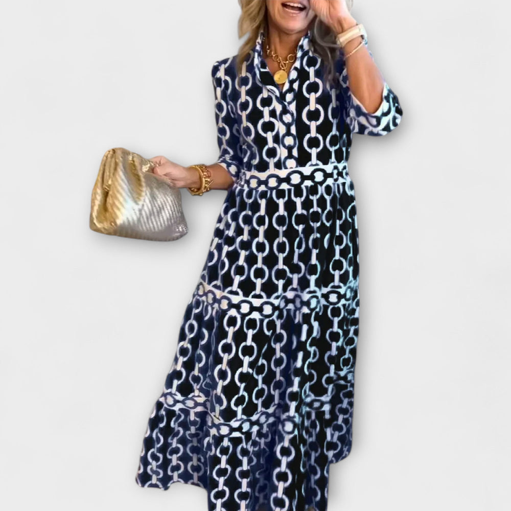 Black women's chain print collared midi dress with long sleeves.