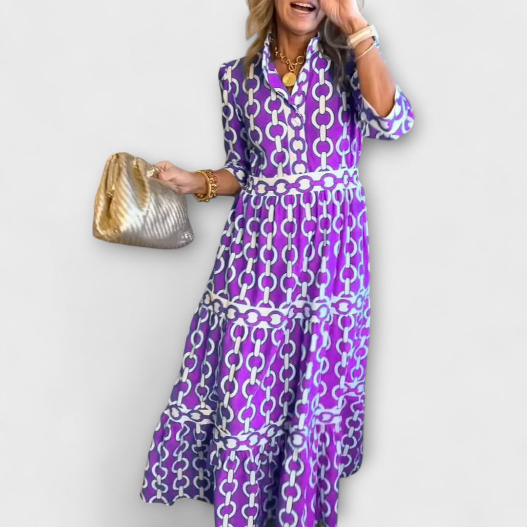 Purple Gwen midi dress with chain print, collar, and long sleeves.