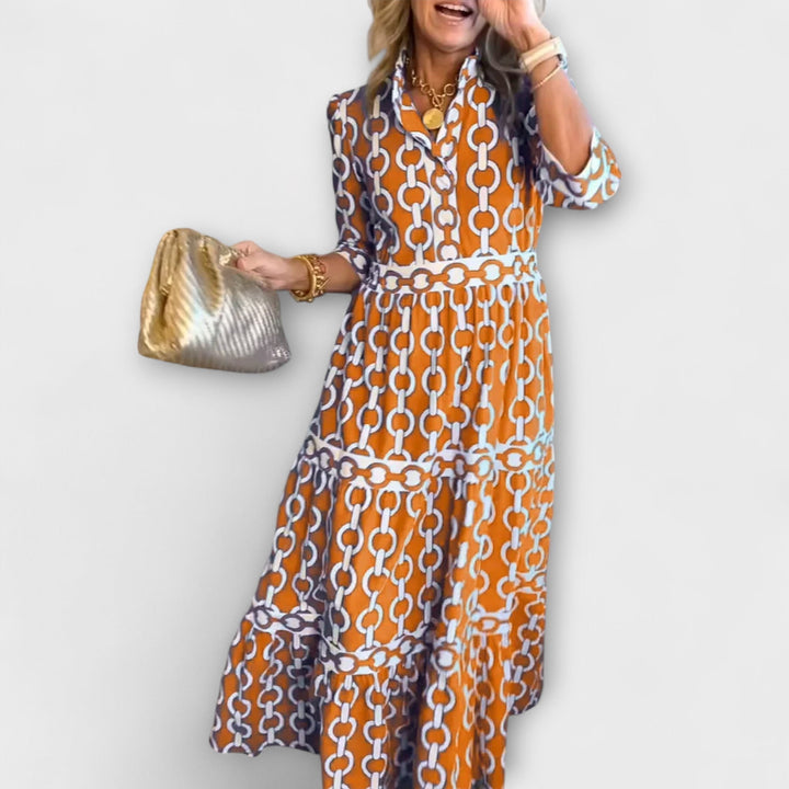 Orange chain print collared midi dress for women, featuring long sleeves and a flowing skirt.