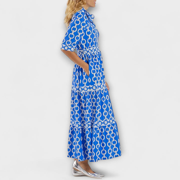 Women's Gwen chain print collared midi dress in black and gold, featuring long sleeves and a flowing skirt.