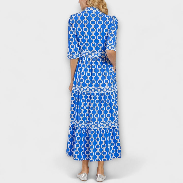 Women's Gwen chain print collared midi dress in black and gold, featuring long sleeves and a flowing skirt.