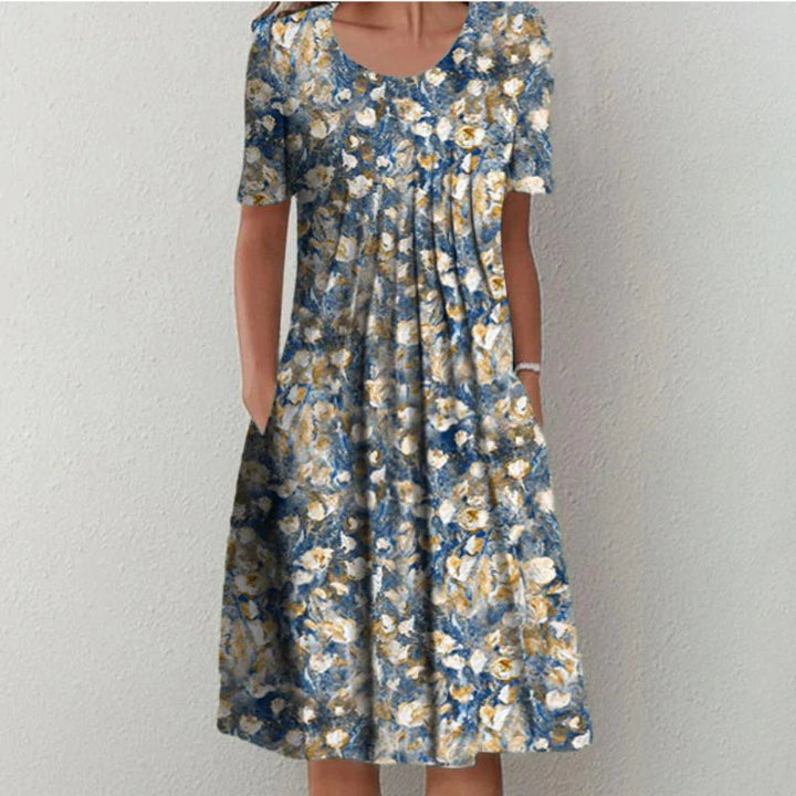 Light blue floral midi dress with pockets, short sleeves, and a flattering silhouette.