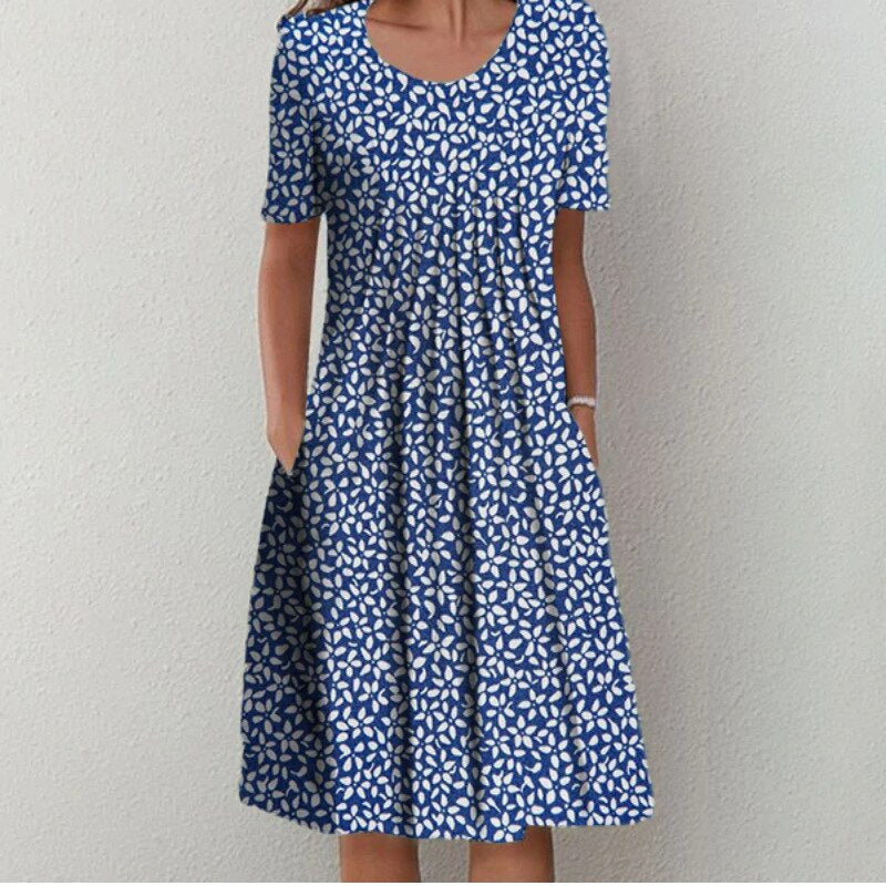 Women's blue floral midi dress with pockets, short sleeves, and a flattering fit.