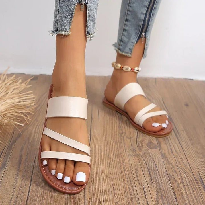 Beige Hattie women's cross strap flat sandals with a comfortable, open-toe design.