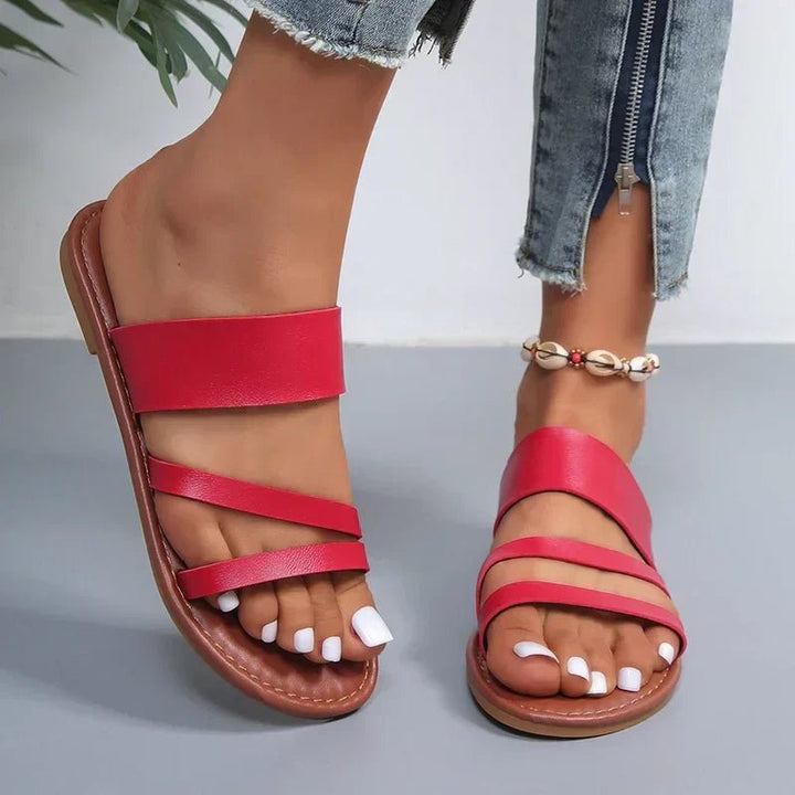 Red women's Hattie cross strap flat sandals with a comfortable sole.