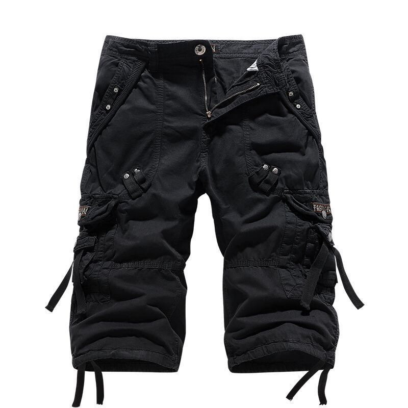 Black men's knee-length cargo shorts with multiple utility pockets, button and zip closure, and tie details.