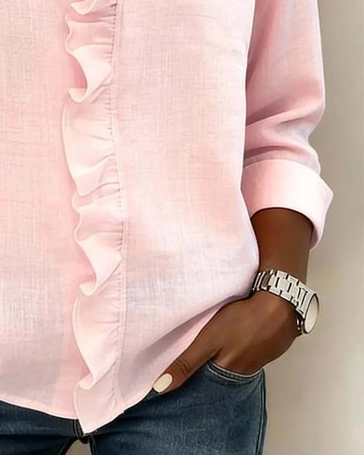 White women's V-neck ruffle blouse with long sleeves, made from a light, flowing fabric.