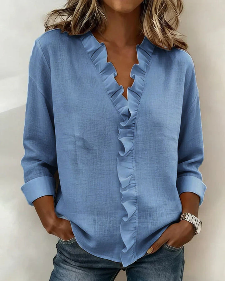 Blue women's V-neck ruffle blouse with long sleeves, made of lightweight fabric.