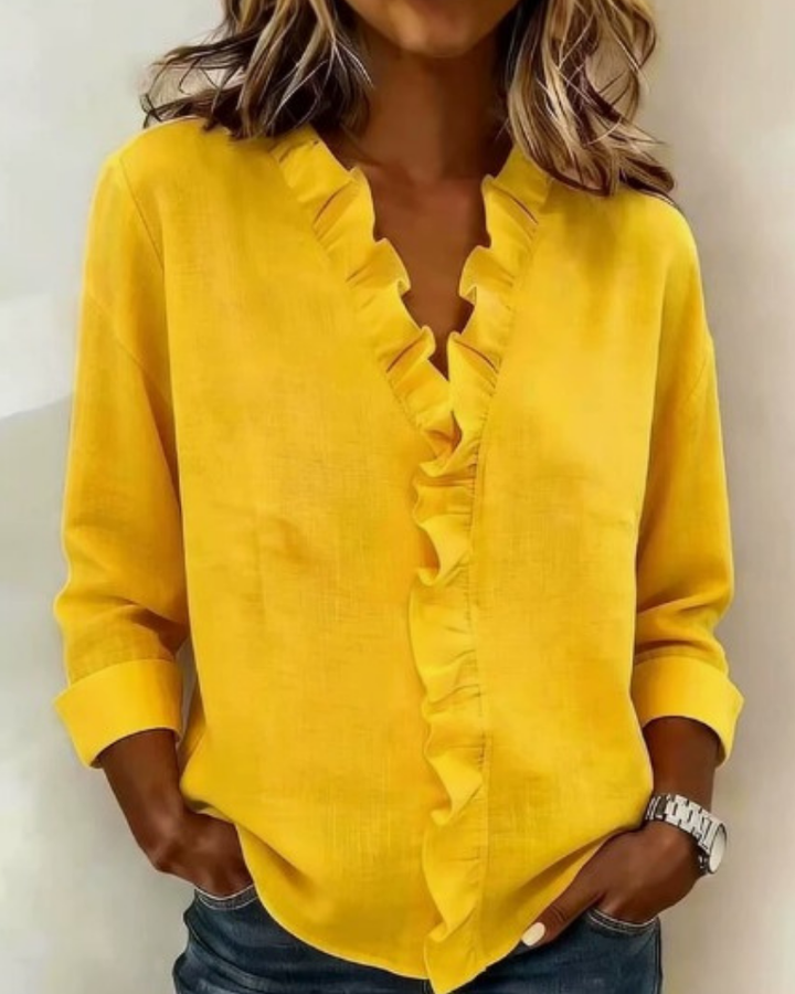 Yellow women's V-neck ruffle blouse with long sleeves, made from a lightweight fabric.