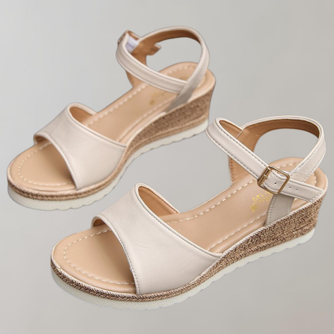 Pair of Kaiya women's orthopedic beige wedge sandals with smooth front strap, adjustable ankle strap, and woven sole.