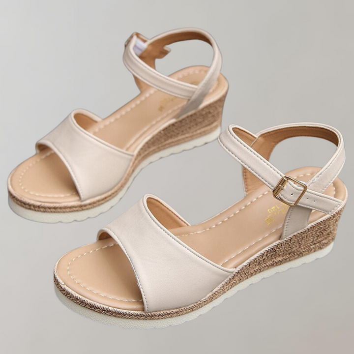 Pair of Kaiya women's orthopedic beige wedge sandals with smooth front strap, adjustable ankle strap, and woven sole.