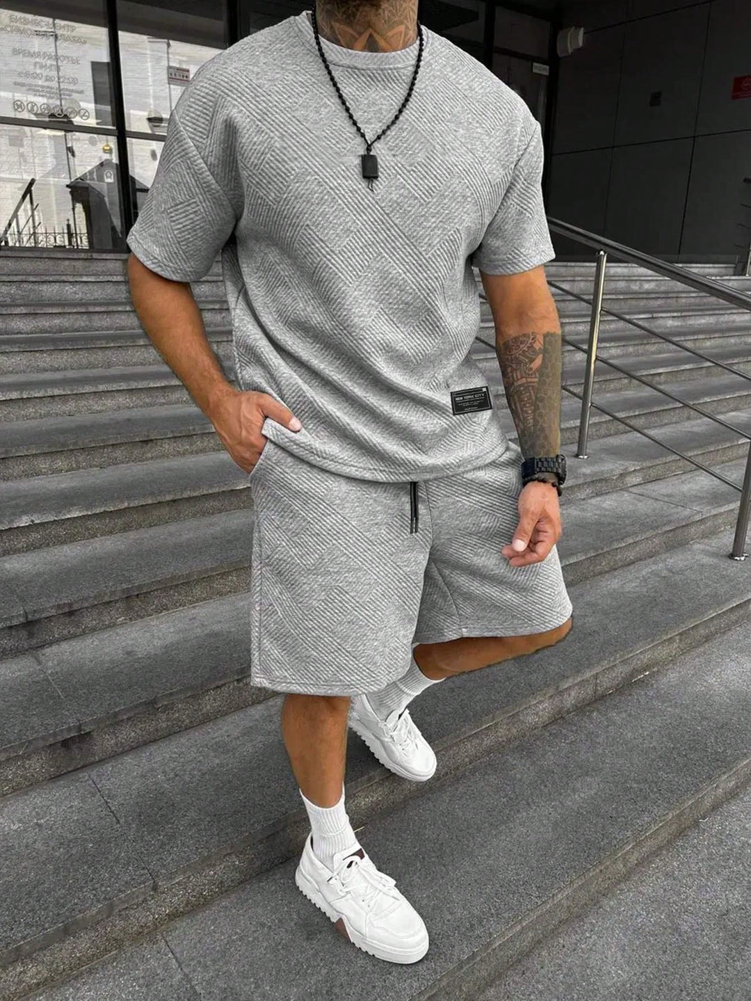 Men's gray textured short sleeve t-shirt and matching drawstring shorts set with side pockets.