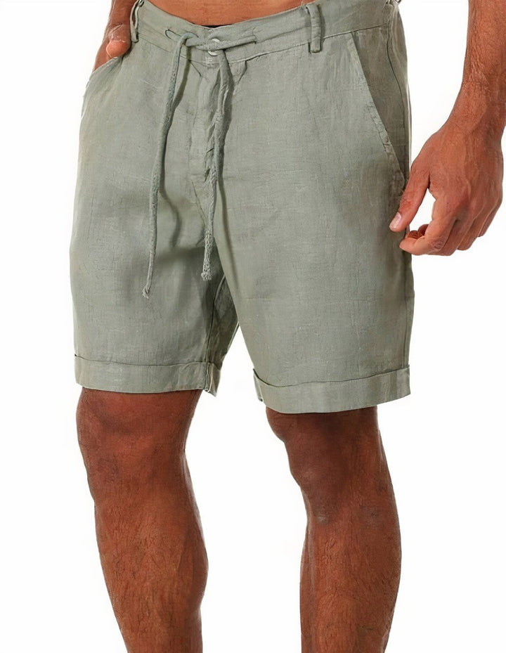 Men's Luca drawstring linen shorts in sage green, featuring a relaxed fit, rolled cuffs, and side pockets.