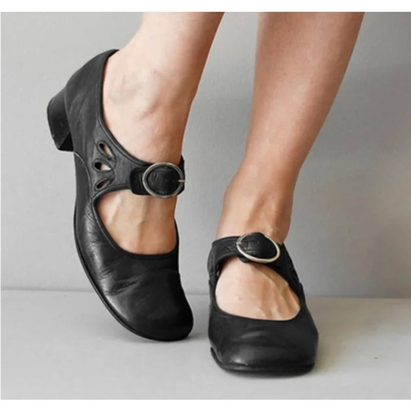 Black leather orthopedic wedge sandals with buckle strap.