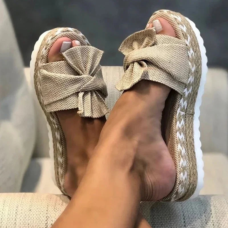Women's Mariah bow platform slide sandals in natural beige with espadrille-style soles.
