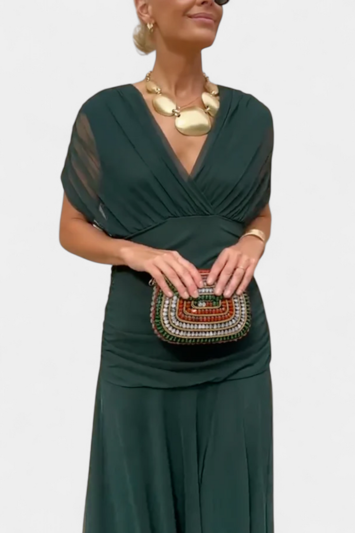 Black off-shoulder ruched maxi dress with sheer long sleeves, elegant and flowing.