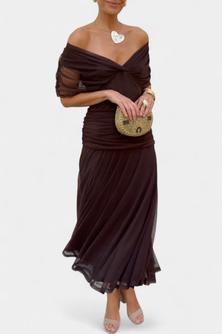 Black off-shoulder ruched maxi dress with sheer long sleeves and a flowing skirt.