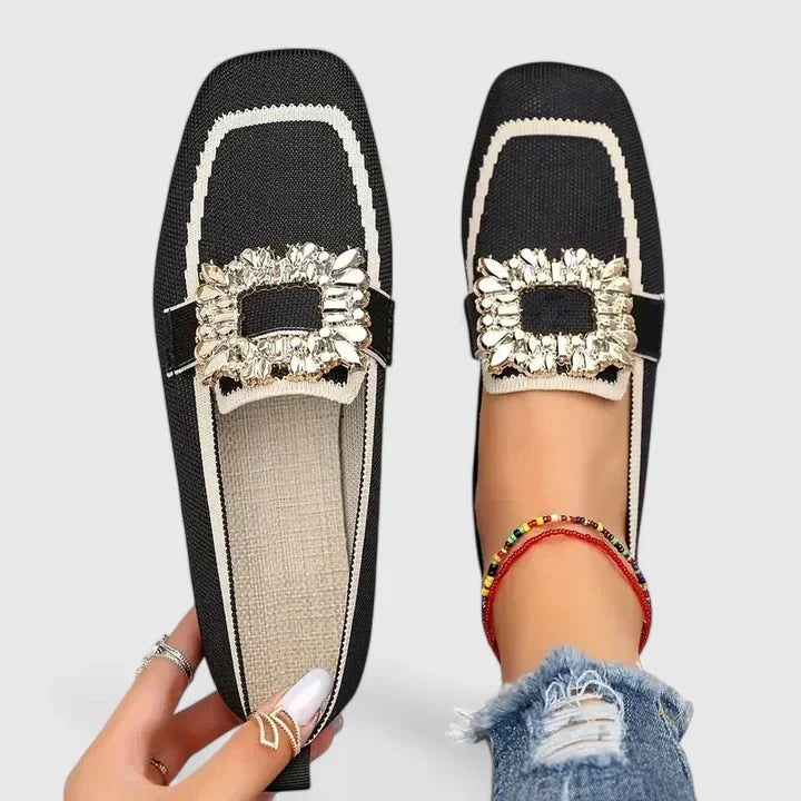 Black Maylora women's orthopedic loafers with a prominent gold statement buckle, crafted from smooth leather.