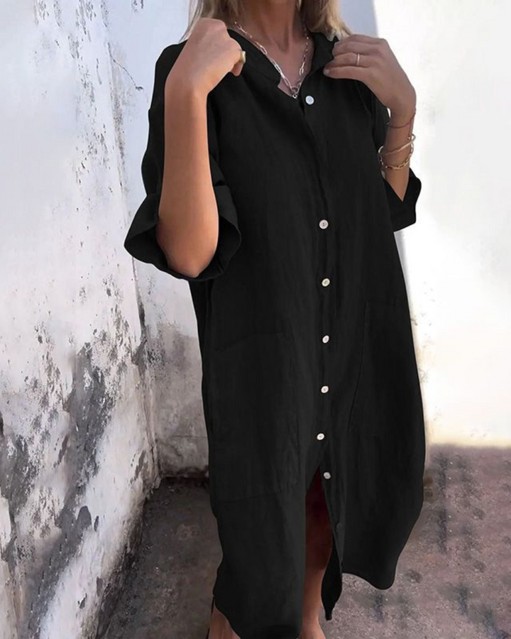 Mina black plus size shirt dress with white buttons, relaxed fit, and front pockets.