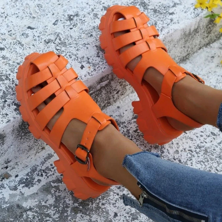 Orange Mira women's platform fisherman sandals with a buckle strap.