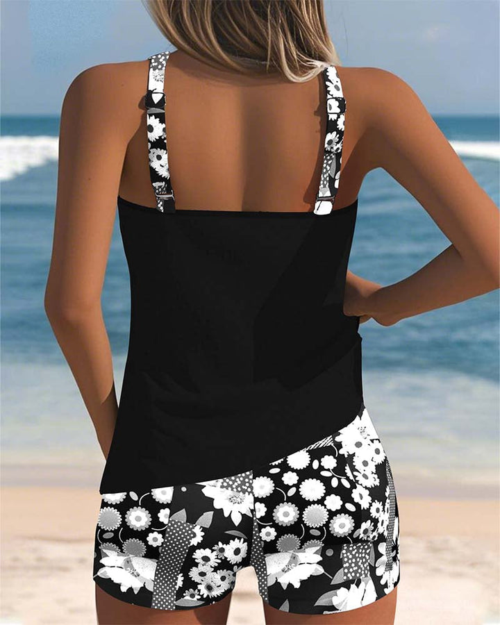 Women's Mirelle tankini with shorts, black top, and floral print bottoms.