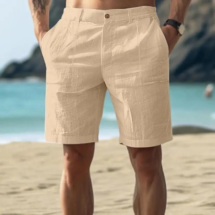 Men's Nico above-knee button-front shorts in a light beige, linen-blend fabric with front pockets.