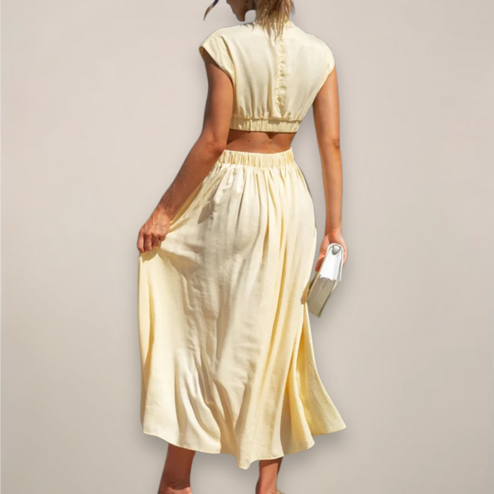 Women's black cutout waist maxi dress with cap sleeves.