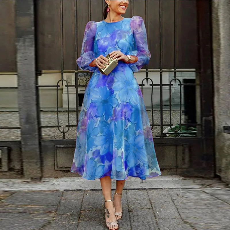 Blue floral midi wedding guest dress with sheer sleeves for women.