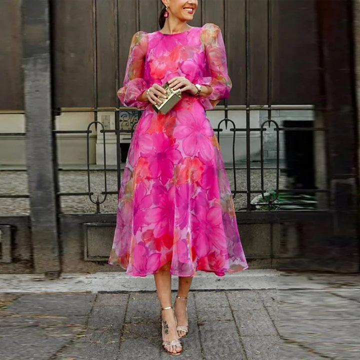 Pink floral midi wedding guest dress with sheer sleeves for women.