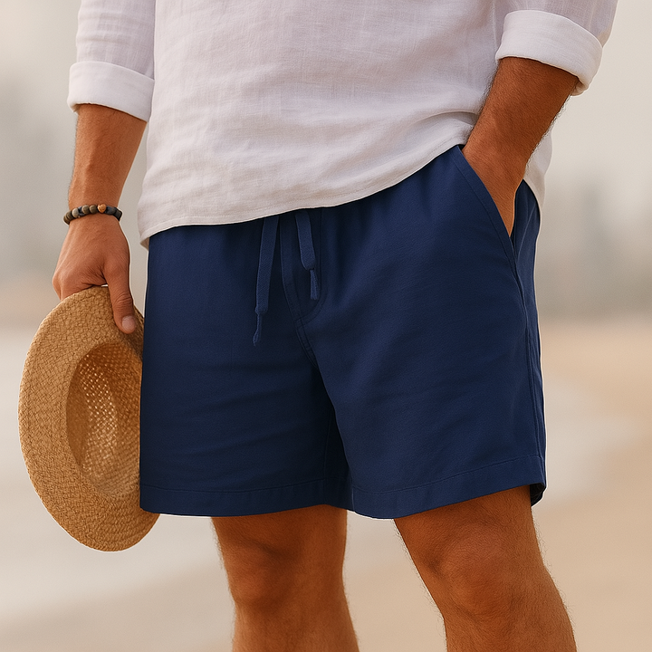 Men's Rafael navy blue drawstring above-knee shorts with side pockets, worn with a white linen shirt.
