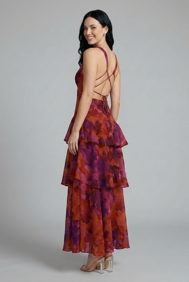 Rosaline floral maxi dress with deep V-neck, layered ruffle skirt, and crisscross back.