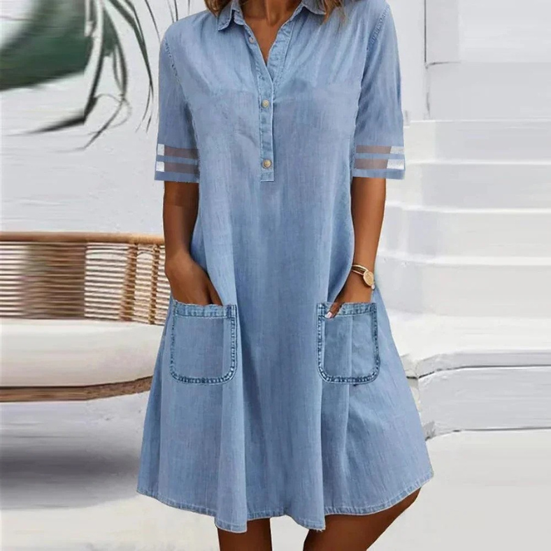 Blue denim shirt dress for women with pockets, short sleeves, and a relaxed fit.