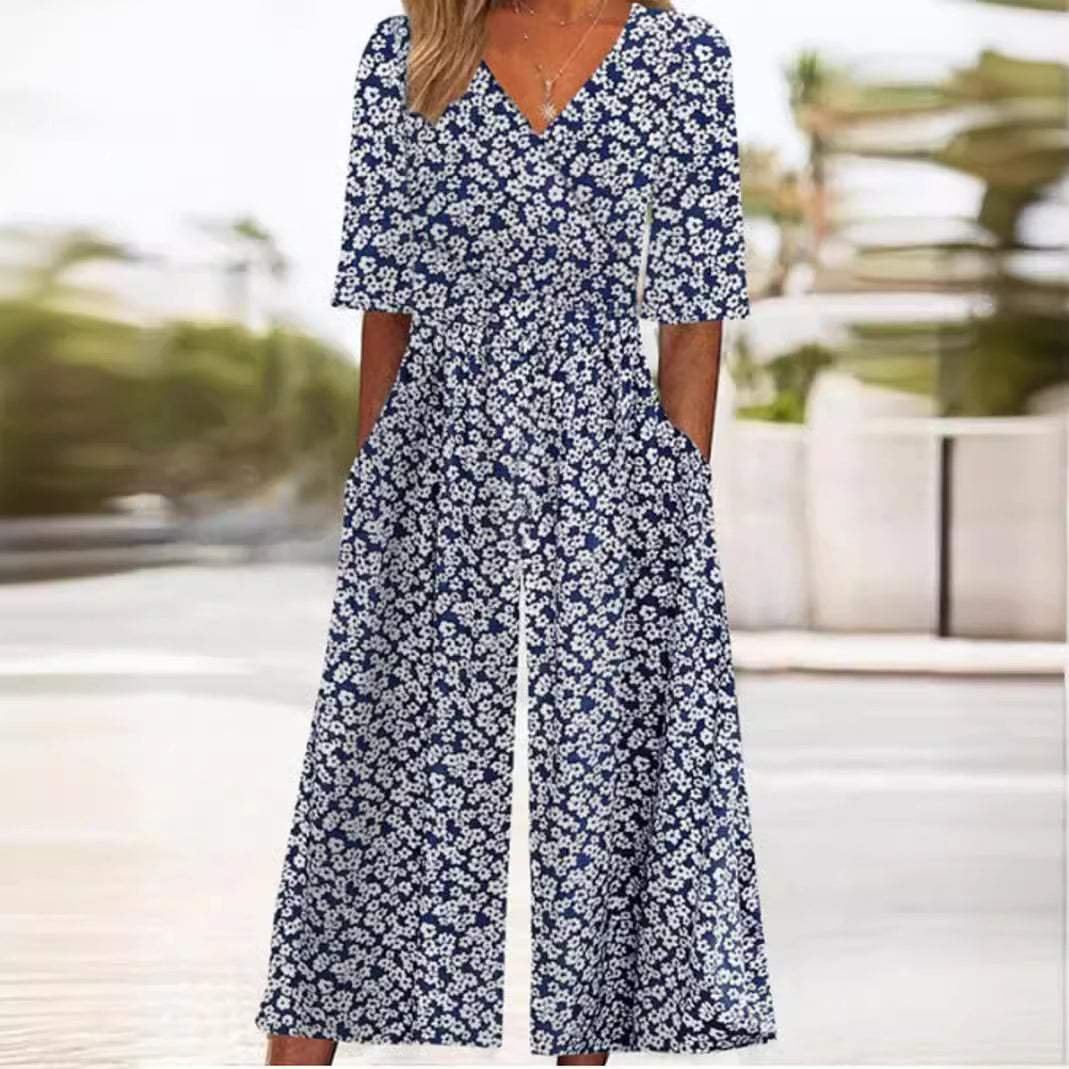 Women's Scarlett navy blue floral wide-leg jumpsuit with V-neck, half sleeves, and pockets.