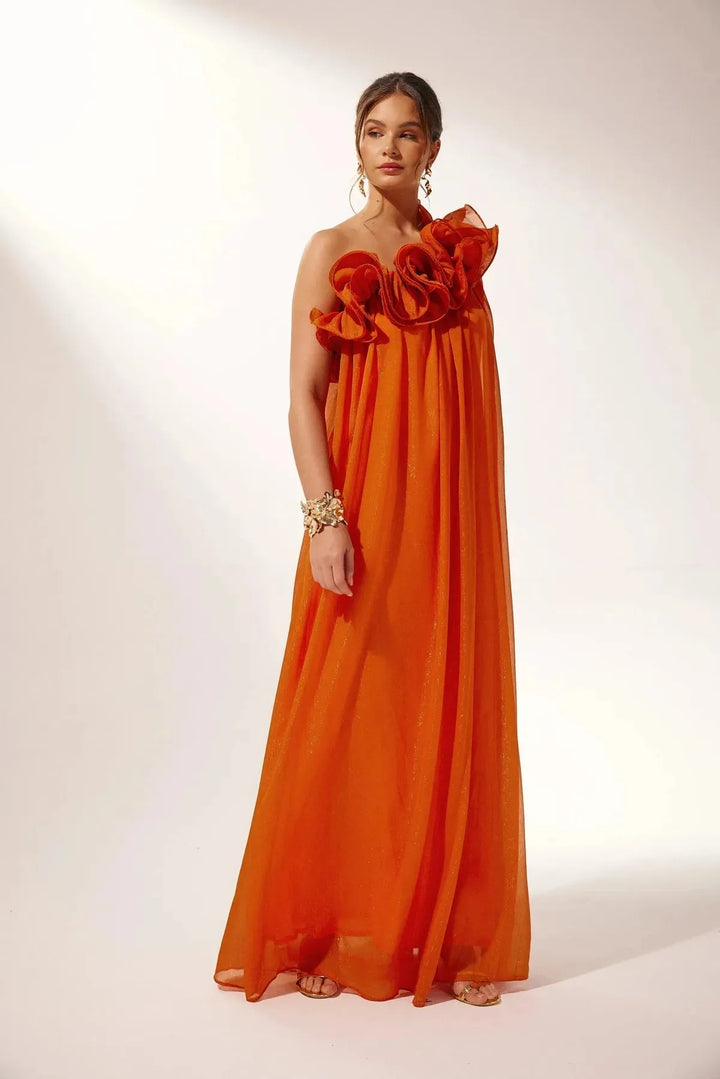 Women's white one-shoulder ruffle maxi dress, flowing fabric.