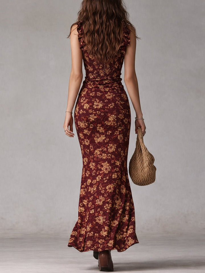 Women's Soraya smocked ruffle maxi boho floral dress in burgundy with gold flowers, seen from behind.