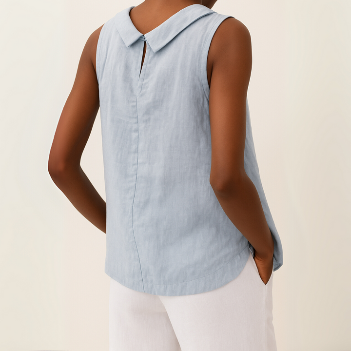 Women's white sleeveless roll collar top with a relaxed fit, made from a soft, flowing fabric.