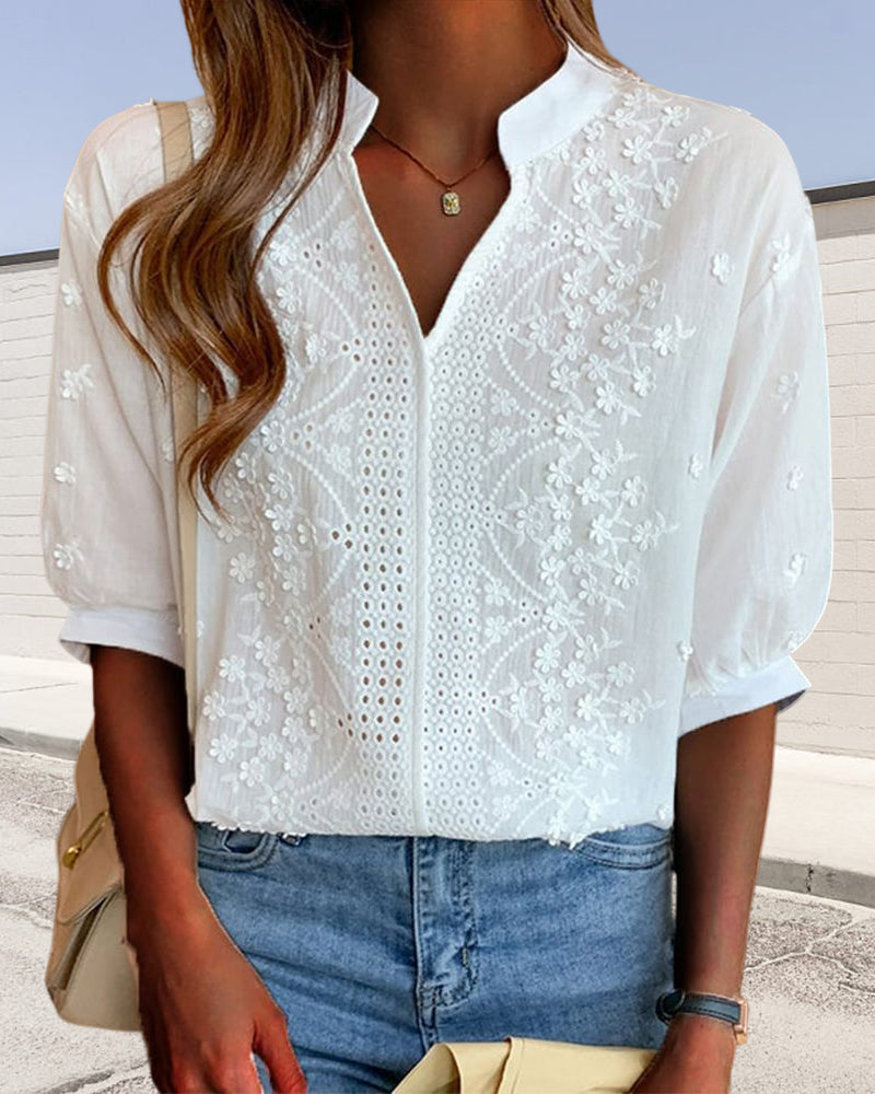 White Tessa women's embroidered V-neck blouse with 3/4 sleeves, made from a lightweight fabric.