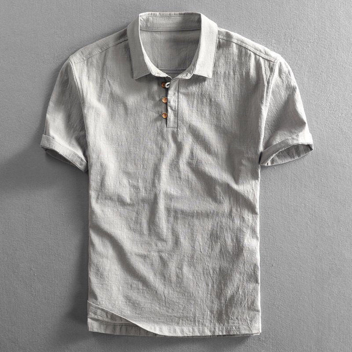 Men's light gray Troy short sleeve polo shirt with a classic collar, button placket, and textured fabric.