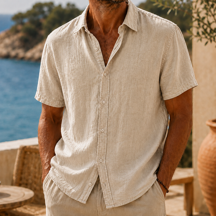 Men's Tyson natural linen short sleeve button shirt with collared neckline, worn outdoors.