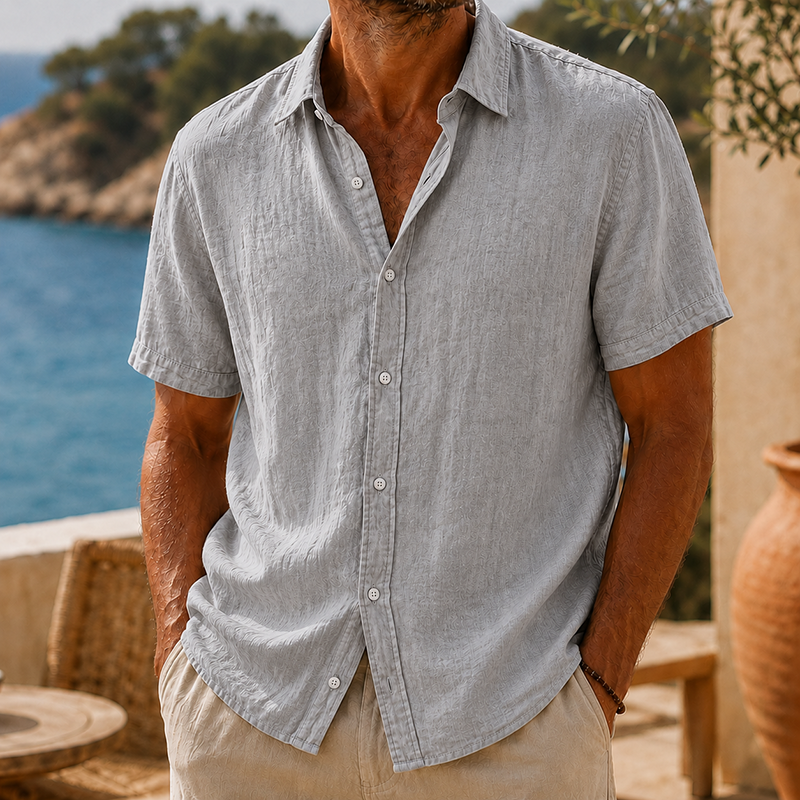 Men's light gray linen short sleeve button shirt with a collared neckline and textured fabric.