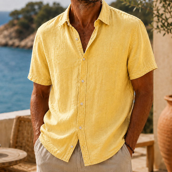Men's Tyson yellow linen short-sleeve button shirt with a collared neckline, worn with light pants.