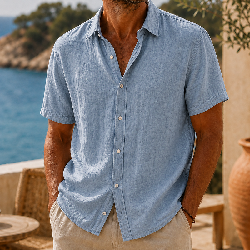 Men's Tyson light blue linen short sleeve button shirt with a collared neckline, worn with khaki pants.