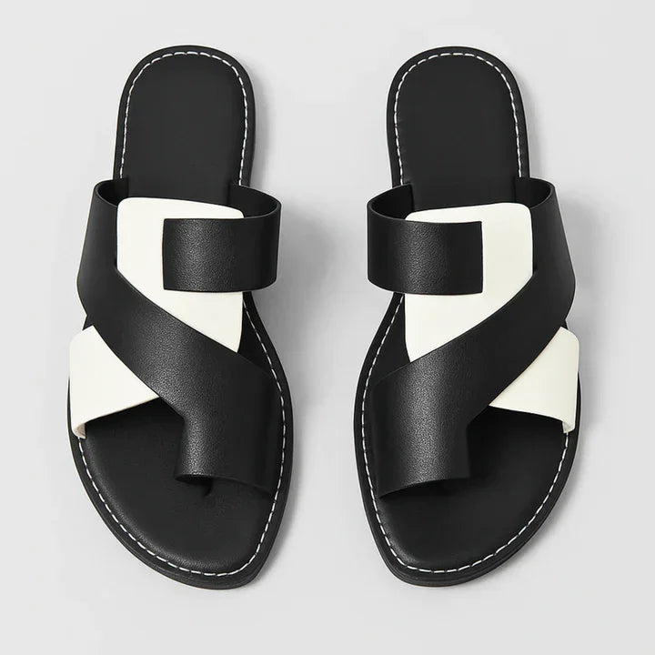 Black & ivory two-tone leather slide sandals for women, featuring a stylish toe loop.