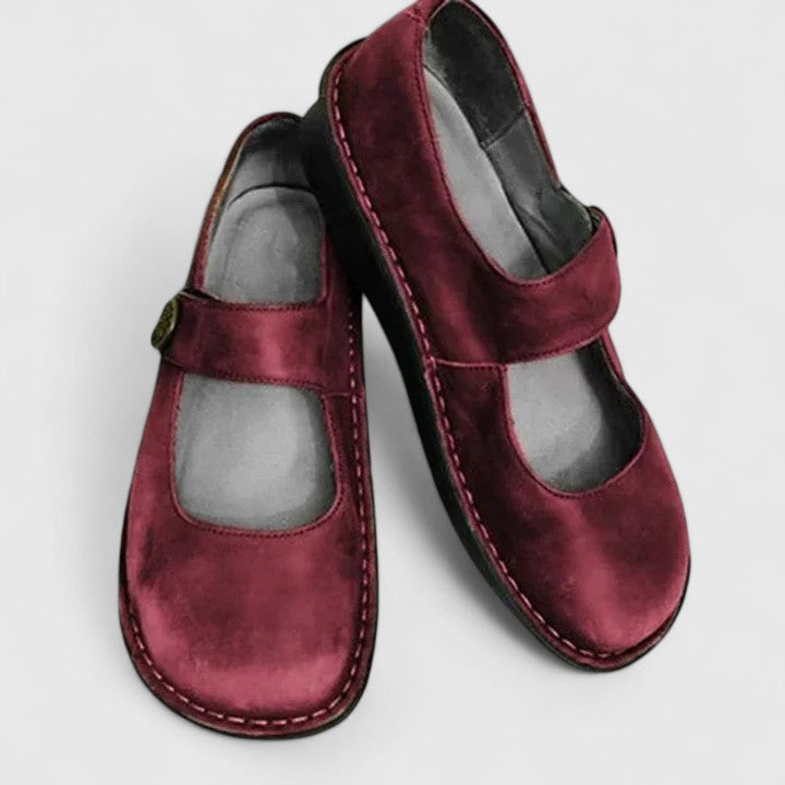 Red leather Mary Jane orthopedic shoes with adjustable strap.