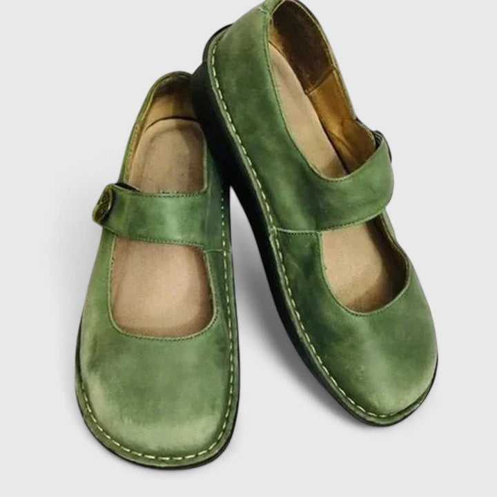 Green leather orthopedic Mary Jane shoes with adjustable strap.
